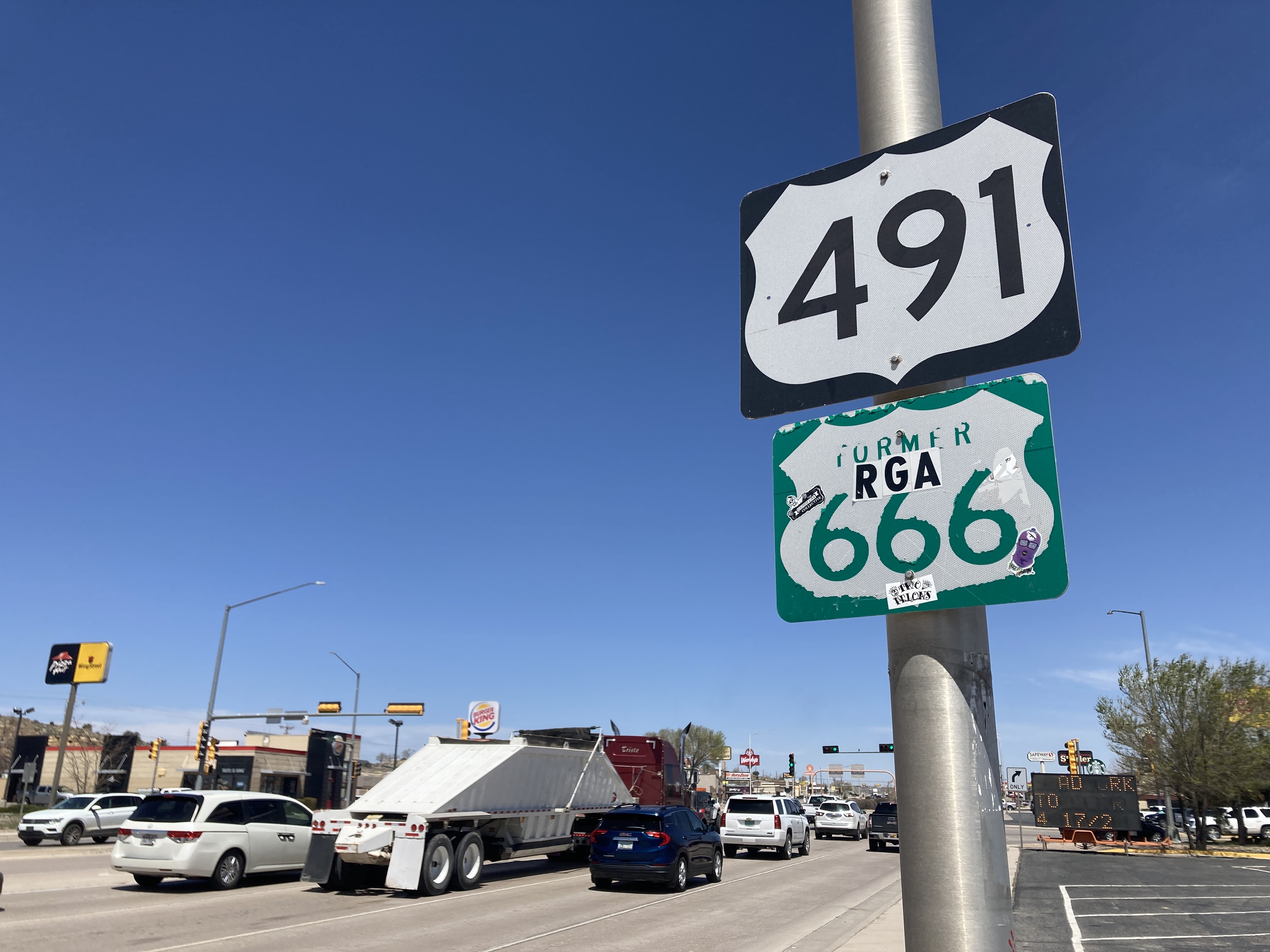Sign of former U.S. Highway 666 below the current sign of Highway 491