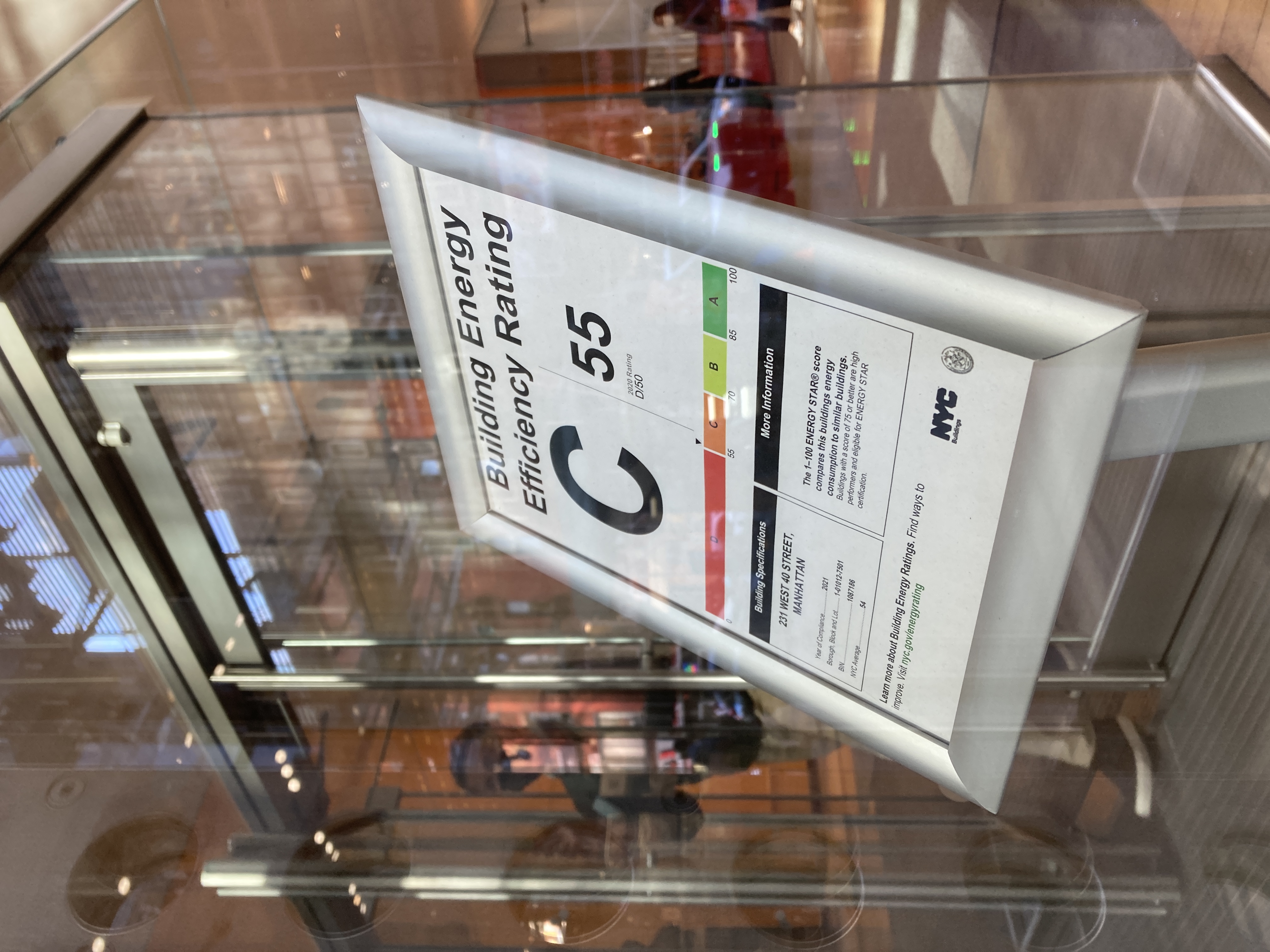 photo of sign inside glass building displaying energy efficiency score of C